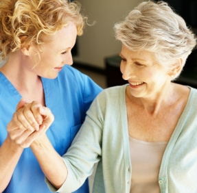 Therapist and Senior Holding Hands